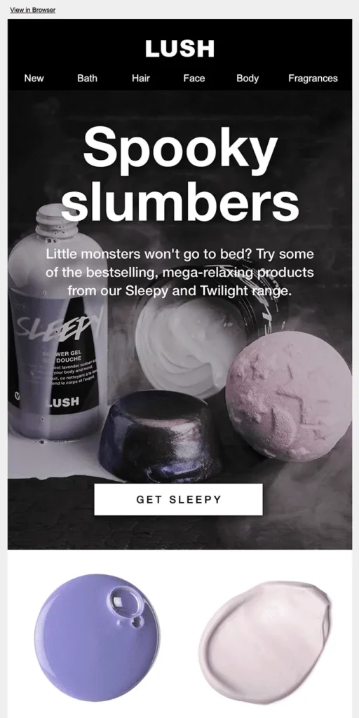 Holiday email example by Lush showing white smoky shampoos and pink bath bombs on a black background.